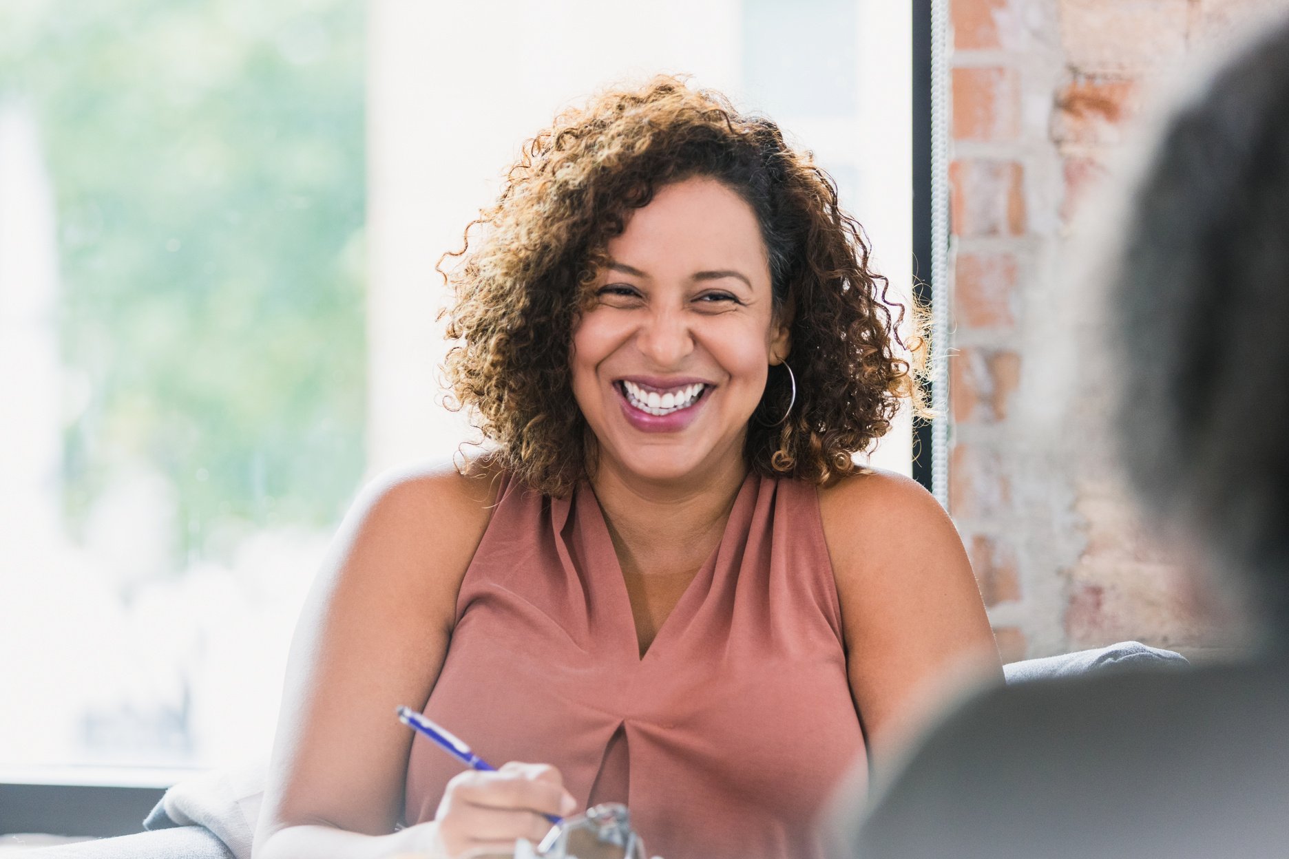 Cheerful female therapist smiling at patient